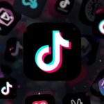 Pessoa brasileira trabalhando em ambiente digital profissional no notebook e no celular para ilustrar Como usar link de afiliado do TikTok.